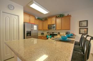a kitchen with a large island with a counter top at South Facing Pool Near Disney 5 Bed Luxury in Kissimmee