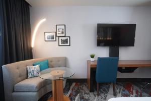 a living room with a couch and a table and a tv at Seven Feathers Casino Resort in Canyonville