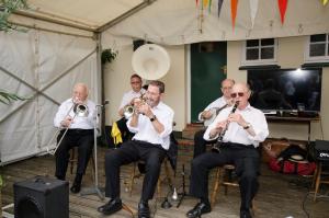 a group of men playing trumpet in a tent at The Compasses in Chelmsford