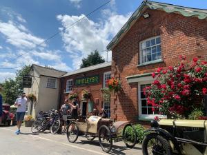 an old car parked in front of a brick building at The Compasses in Chelmsford