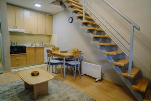 a kitchen with a table and a staircase in a room at Košuta 21 Center Duplex Apartment, Brzeće in Brzeće +25 photos