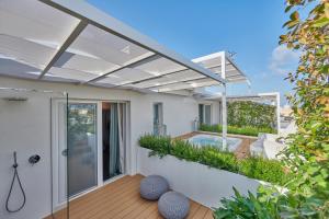 a modern house with a pool and a patio at Musae Relais & SPA in Polignano a Mare