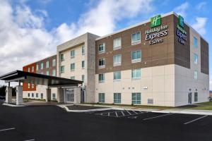 a hotel building with a parking lot in front of it at Holiday Inn Express & Suites - Ottawa, an IHG Hotel in Ottawa