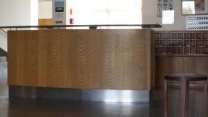 a wooden counter in a room with a table and stool at Flag Hotel Porto Maia in Águas Santas