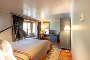 a hotel room with a bed and a desk at The Outlook Lodge in Green Mountain Falls