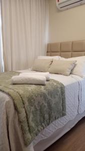 Una cama con dos almohadas encima. en Apart Hotel Vista Azul - hospedagem nas montanhas en Domingos Martins