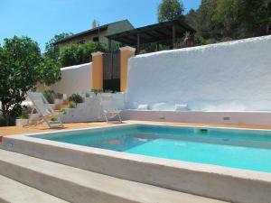 a swimming pool in the backyard of a house at Theano Cottage in Gaios