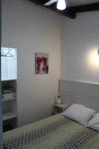 1 dormitorio con 1 cama y una foto en la pared en Residencial Annabel Apto 04, en Bombinhas