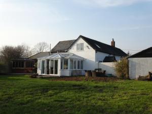 a white house with a large yard at Hunters Croft in Sway