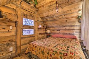 a bedroom with a bed in a log cabin at Mtn Cabin Between Bryce Canyon and Zion Natl Parks! in Long Valley Junction