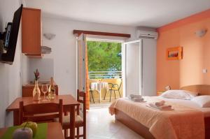 a bedroom with a bed and a table with a dining room at Promenada - Beachfront Apartments in Tučepi