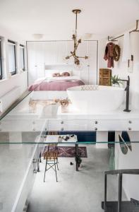 a bedroom with a glass table and a bath tub at Hedo & Art Loft - Old Town in Poznań