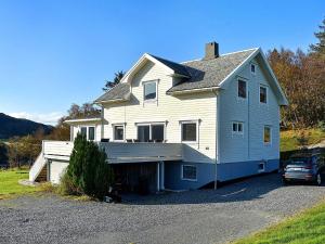 ein weißes Haus mit einem davor geparkt in der Unterkunft Holiday home MIDSUND V in Midsund