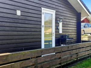 a house with a porch with a door and a window at 6 person holiday home in Nordborg in Nordborg