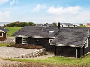 a house with a black roof at 6 person holiday home in Nordborg in Nordborg