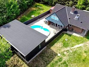 an overhead view of a house with a swimming pool at 8 person holiday home in H jslev in Bøstrup