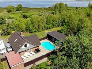 an aerial view of a house with a swimming pool at 8 person holiday home in H jslev in Bøstrup