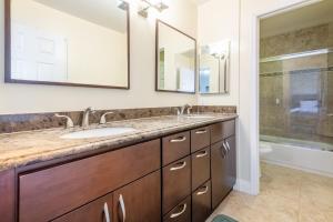 a bathroom with a sink and two mirrors at Luxury San Diego House, Beach, Pool & Pet-Friendly in San Diego +21 photos