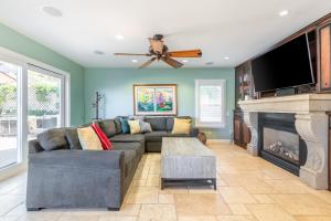 a living room with a couch and a fireplace at Luxury San Diego House, Beach, Pool & Pet-Friendly in San Diego
