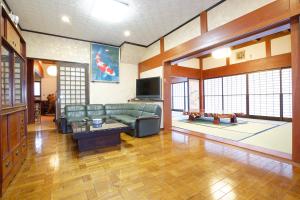 a living room with a couch and a tv at 能生の家 in Itoigawa