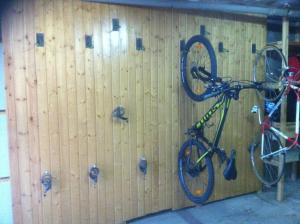 a bike parked in front of a wooden wall at Hotel La Burna Panoràmic in Sispony