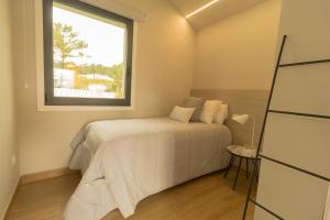A bed or beds in a room at Alto da Pousa