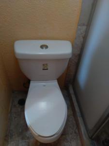 a bathroom with a white toilet in a stall at IOW4 LM Junior Suite in Acapulco