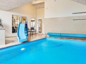 a swimming pool with a slide in a house at 18 person holiday home in H jby in Højby
