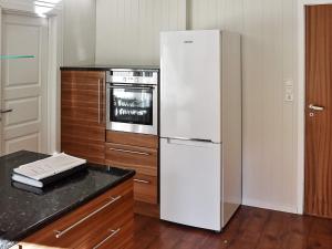 a kitchen with a white refrigerator and a stove at 10 person holiday home in skei i jølster in Årdal