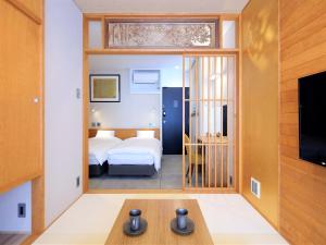 Rúm í herbergi á Tanakaya Kyoto Karasuma