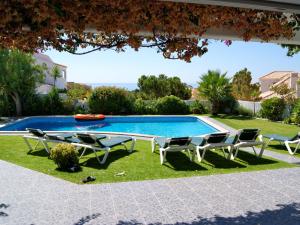 a pool with chairs and a table and a swimming pool at Fantastic Villa in Albufeira with Private Swimming Pool in Albufeira