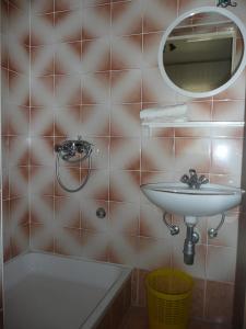 a bathroom with a sink and a mirror and a tub at Apartment in Rab/Insel Rab 16488 in Mundanije