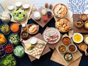 a table topped with lots of different types of food at Vessel Hotel Campana Susukino in Sapporo