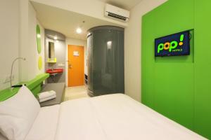 Rúm í herbergi á POP! Hotel BSD City Tangerang