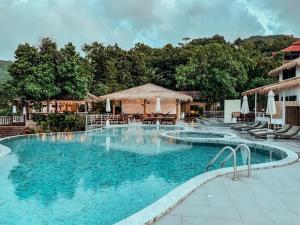a large swimming pool with chairs and a gazebo at High Life Bungalow in Haad Yao