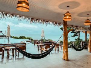 a resort with hammocks and tables and a view of the ocean at High Life Bungalow in Haad Yao