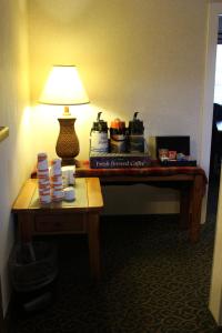 a table in a hotel room with a lamp on it at Quality Inn & Suites Goldendale in Goldendale
