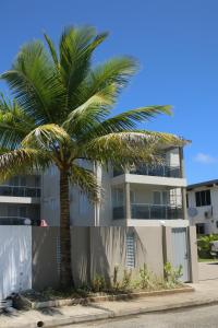 a palm tree in front of a building at FIJI HOME Apartment Hotel in Suva