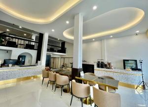 una cucina con bancone con tavolo e sedie di Topnorth Hotel Maesai a Mae Sai