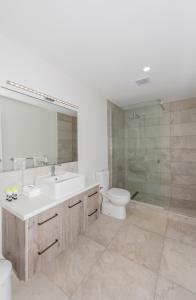 a bathroom with a sink and a toilet and a shower at The Hub Bicheno in Bicheno