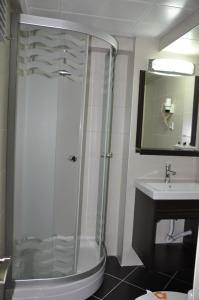 a bathroom with a shower and a sink at Hotel Kabacam in Izmir