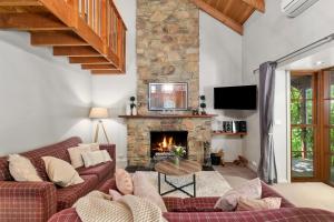 uma sala de estar com um sofá e uma lareira em Stonehenge Retreat em Ballarat