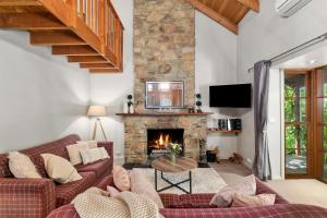 a living room with a couch and a fireplace at Stonehenge Retreat in Ballarat