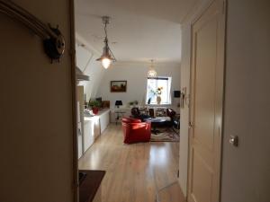 a living room with a red chair and a couch at Het Speijerhuis in Harlingen