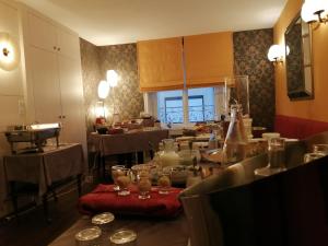 a dining room with tables and chairs and a room with tablesktop at Logis Hôtel Restaurant La Breche in Amboise