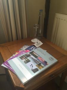 a book sitting on a wooden table at Swan Hotel & Spa in Lavenham