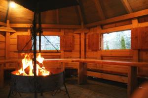 a fireplace in a log cabin with two windows at DW Pod Jaworami - relaks w SPA - jacuzzi, sauna na wyłączność in Białka Tatrzanska