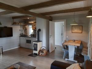 a living room with a table and a stove at Sofia Chalet in Bublava