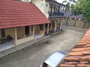 an overhead view of a house with a red roof at Hotel Putra Sindang Asih in Batukaras