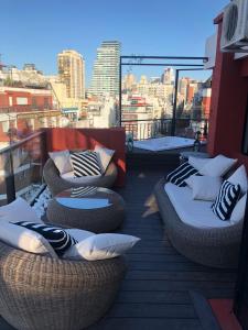 a balcony with couches and pillows on a roof at GATE Recoleta in Buenos Aires